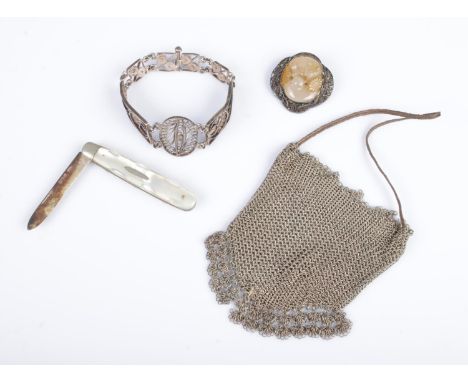 A Chinese silver wirework brooch with carved plaque depicting cats, together with a silver bladed fruit knife, wirework brace