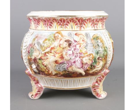 A Capodimonte planter with gilt banding and depicting figures and cherubs to three panels. Raised on three squat feet. Diamet