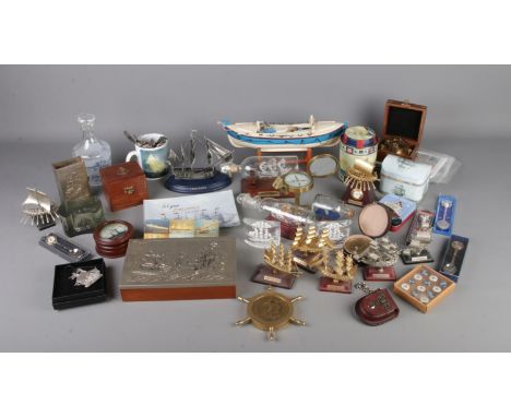 A quantity of nautical themed collectables including model boats, souvenir spoons, trinket boxes, tins, compasses, replica ti