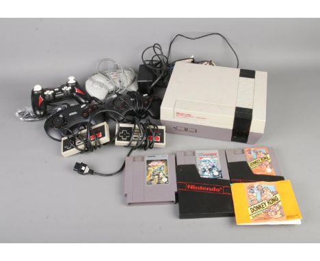 A Nintendo Entertainment System games console along with a selection of unboxed games to include Donkey Kong Classics, Probot
