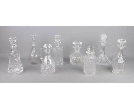 Eight glass decanters, including ship and examples with star cut bases.  Crack to the shoulder of one example.