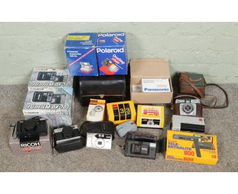 A collection of vintage cameras, including Kodak Instamatic 33/200, Panasonic Zoom, Ilford Sportsmax, Polaroid Supercolor 635