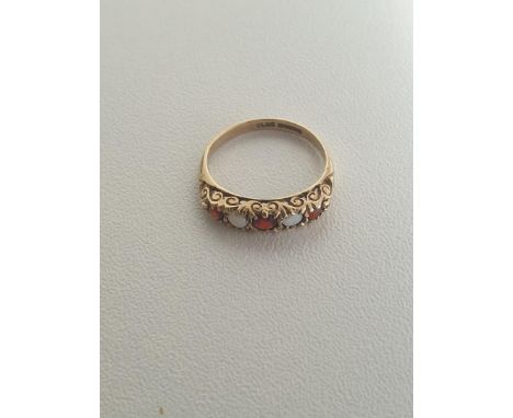 9ct gold garnet and white opal five-stone set ring, gross weight 1.3g size J. Shipping Group (A). 