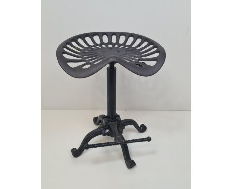 Height adjustable cast metal stool having tractor seat and foot rest. Collection only. 