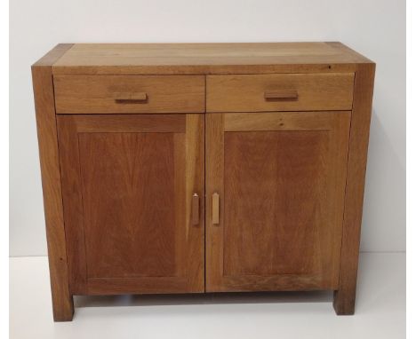 Contemporary light oak cupboard having 2 drawers over 2 lower doors, opening to reveal cupboard space with central shelf. H:9