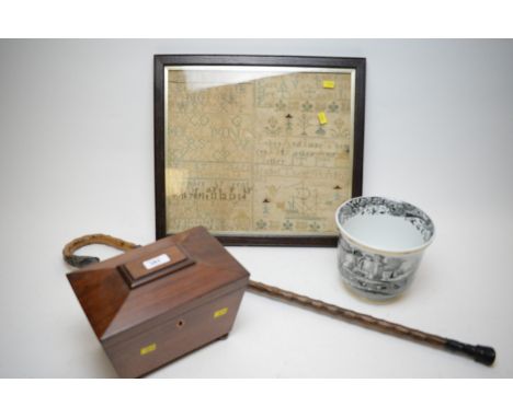 An early 19th Century mahogany sarcophagus-shaped tea caddy, hinged lid enclosing two foil-lined compartments, on turned bun 