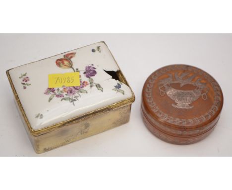 A 19th Century silver-gilt and porcelain covered snuff-box, the hard case porcelain cover painted with floral sprays, on a gi