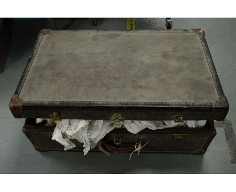 A Watajoy travel trunk, containing a selection of children's nightdresses and other clothing, c.19th/early 20th Century.