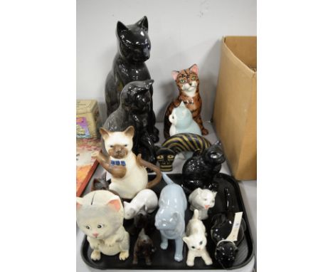 A collection of ceramic cats, including: two large black glazed cat ornaments; and others.