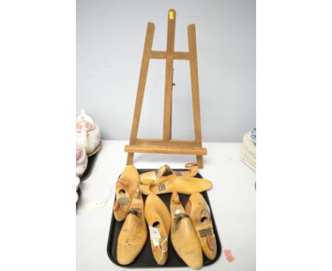 Seven hinged beech shoe stretchers; together with a tabletop Artist's easel.
