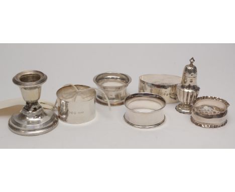 Collection of silver napkin rings, of various designs; a small silver pepperette of half fluted baluster form; and a silver c