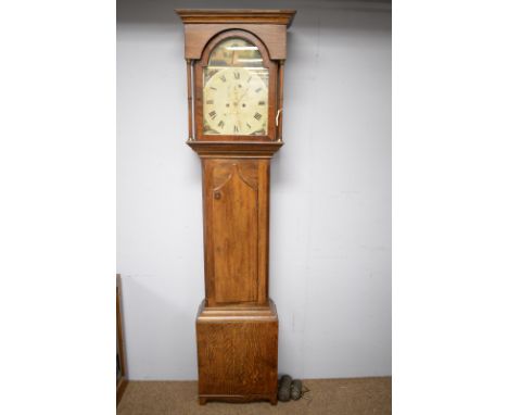 A late 19th Century oak longcase clock, the painted and arched dial, with Roman hours and subsidiary second and date dials an