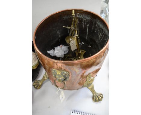 Copper and brass oval coal bin with double brass lion mask and ring handles, on four paw feet; together with a pair of pan sc