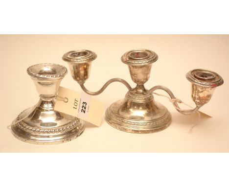A silver three light candelabra, by Addie Bros, Birmingham 1960; together with a silver dwarf candlestick, by what Chris Watr