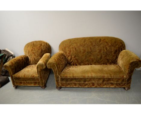 An early 20th Century two-seater sofa, floral upholstery with modern loose covers, and an armchair to match.