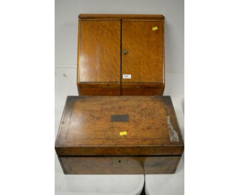 A late Victorian light oak table stationery cabinet, with lift up top and out fold doors enclosing various filing compartment