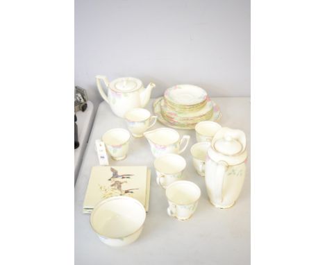 A Royal Doulton Nerissa part floral tea service; together with three tile teapot stands.