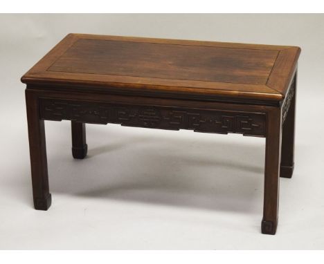 A CHINESE HARDWOOD RECTANGULAR TABLE, with carved frieze and supported on four scroll feet, 47cm high, 78.5cm long, 43cm deep