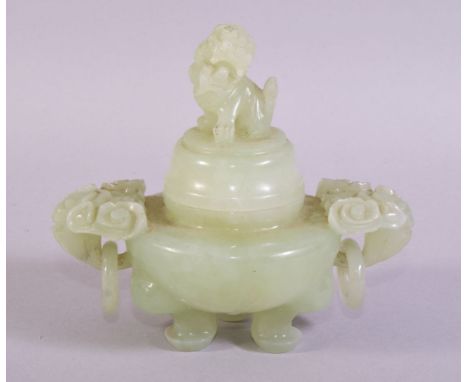 A CHINESE CARVED JADE KORO AND COVER, with carved ring handles, the cover with carved lion dog, supported on three feet, 13cm