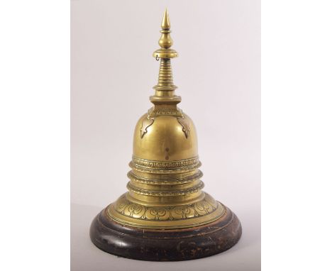 A RARE INDIAN BRASS STUPA, fitted to a wooden stand, 28cm high.