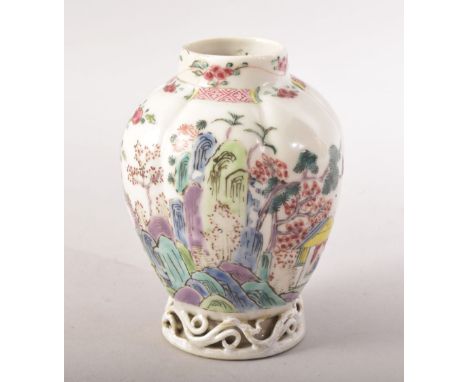 A SMALL CHINESE FAMILLE ROSE CADDY / VASE, painted with flowers with pierced vine base, 9.5cm high.