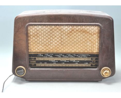 A 1930's Art Deco bakelite valve radio by Cossor. The domed bakelite case with decorative black dial with fabric speaker faci