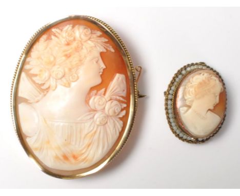 Two vintage 20th Century cameo brooches having carved conch shell panels,&nbsp; both set in yellow metal / gilt mounts, the s