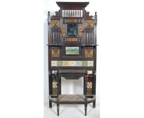 A 19th Century Victorian mahogany framed tiled hall stand with a carved pediment to the top, and a central bevelled edge mirr