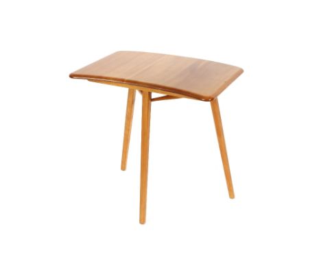 An Ercol side table, having curved top raised on rounded tapering supports, 68cm wide x 44cm deep overall x 71cm high 