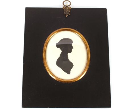 An early 19th Century silhouette of a gentleman and another silhouette of a lady both in period papier m&acirc;ch&eacute; fra