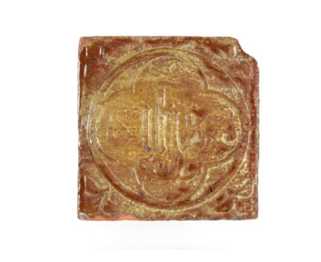 A Medieval period encaustic floor tile with inscription "I.H.S." 11.5cm sq.
