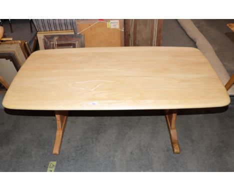 An Ercol coffee table, raised on shaped end supports, 126cm wide x 68cm deep x 52cm high 