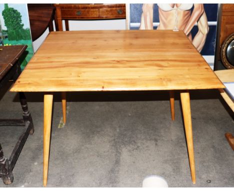 An Ercol kitchen table raised on rounded tapering supports, 93cm wide x 85cm deep x 72cm high