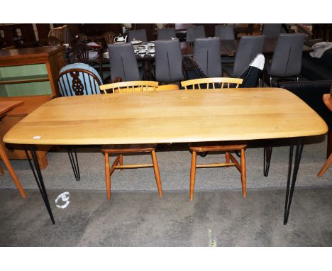 An Ercol dining table, raised on metal hair pin supports, 175cm wide x 78cm deep x 72cm high 