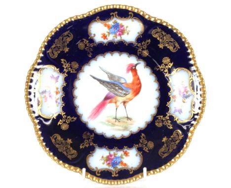 A continental porcelain part dessert set, richly decorated birds and flowers on a blue ground, heightened in gilt, comprising