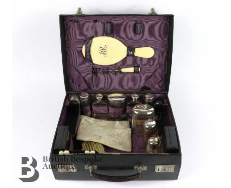 John Bagshaw &amp; Sons Liverpool, George V leather travelling vanity case. The case contains silver-topped accessories Londo