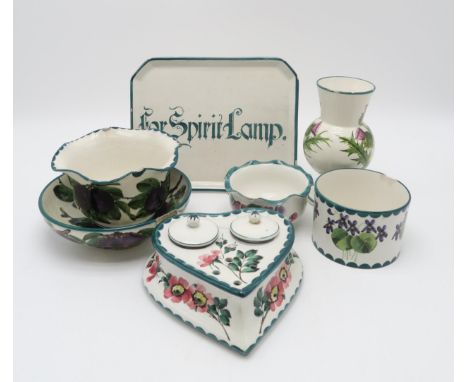 A collection of Wemyss ware including a heart shaped inkwell painted with dog roses, a 'For Spirit Lamp' tray, a plum decorat