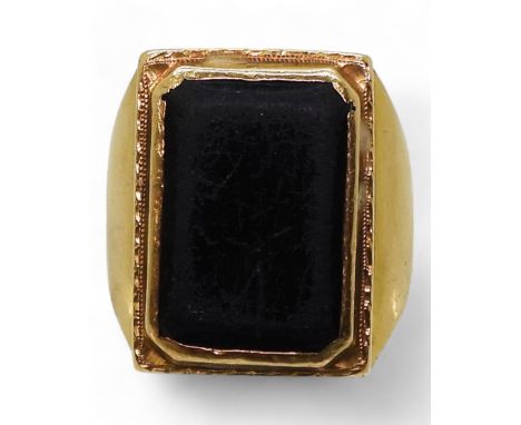 A bright yellow metal ring, set with a black gem, stamped 90% with Chinese symbols, size R, weight 10.8gms Condition Report:A