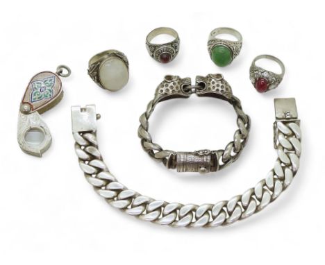 A white metal curb chain bracelet with leopard's head finials, a further example both stamped 925, a large moonstone ring, an