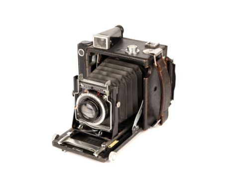 A Graflex Speed Graphic Camera, with Voigtlander Helomar f/3.5 105mm lens, compelte with roll film back