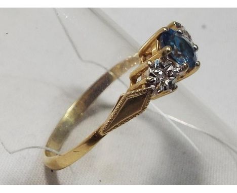 A lady's 9 carat gold hallmarked topaz and diamond trilogy ring, size R, boxed, approximate weight 1.9 grams