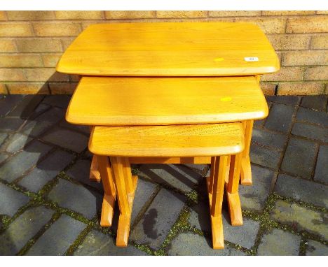 Ercol - A set of three rectangular graduate blonde wood nest of tables 