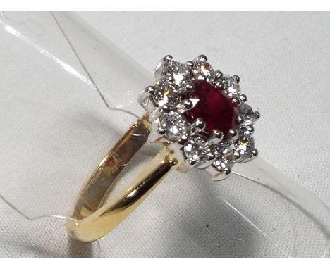 A lady's 18ct yellow and white gold ruby and diamond cluster ring, ruby approx 0.75 carat with approx 0.65 point total diamon