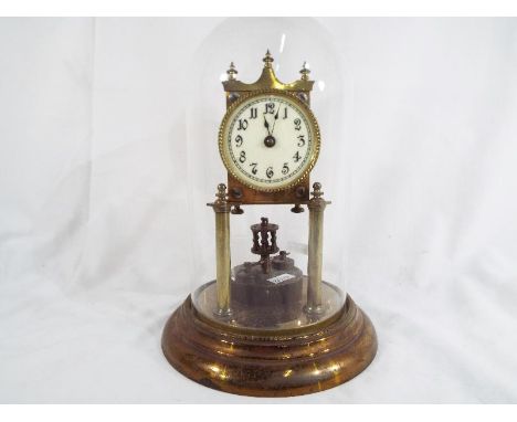 A 400-day Anniversary clock, mechanical movement by Jahresuhrenfabrik mounted on pillars and surmounted by a top pediment wit