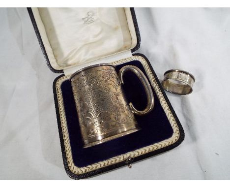 A George V silver tankard, Sheffield assay 1907 approximate weight 136 grams and a hallmarked silver napkin ring Birmingham a