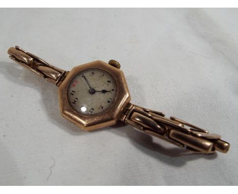 A 9ct gold wrist watch with ceramic face and expandable 9ct gold bracelet Est £80 - £120