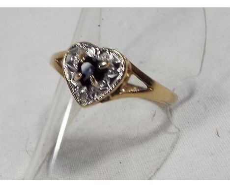 A lady's 9ct gold heart shape sapphire and diamond ring, 1.7 grams