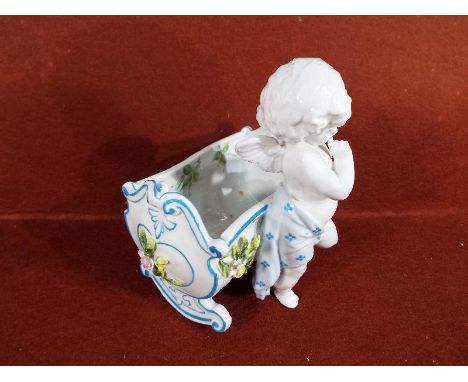 A good quality ceramic posy vase in the form of a cherub and cradle, possibly Sitzen Gorf