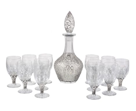  Asprey, a silver coloured mounted glass decanter and stopper with twelve goblets,   the silver apparently unmarked, the glas