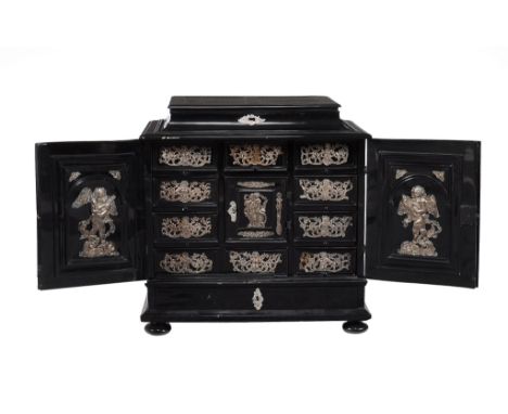 Ω A Flemish ebony and repousse worked silver coloured metal mounted table cabinet , late 17th century style, the hinged cover